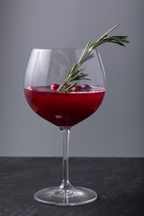 Cranberry juice in wine glass with fresh berries 