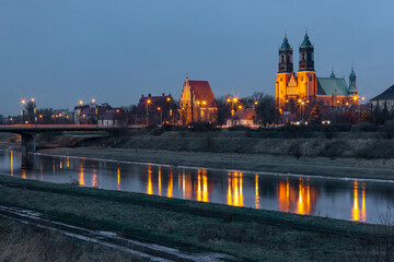 Naklejka premium Poznan Cathedral with reflection in Warta River at night, Poznan, Poland