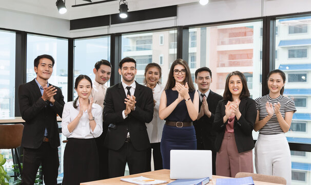 Group of business people standing and clapping for congratulation at the office.
