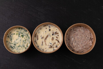 Different bread spreads in paper take away containers