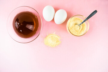 Gelatin and eggs are the main foods containing collagen, essential for youthful skin and healthy joints. Minimalist concept of proper nutrition. Light pink background. Copy space.