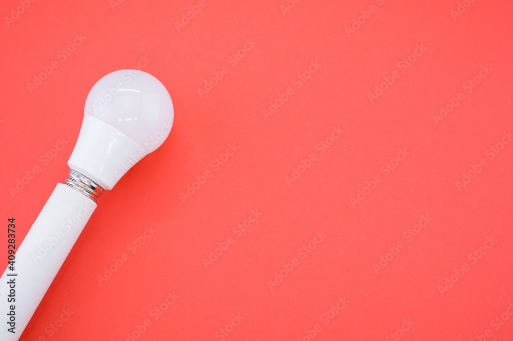 Sticker A closeup shot of a LED light bulb isolated on a red background