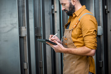 Worker with a digital tablet at the plant