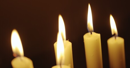Candles glowing against dark background