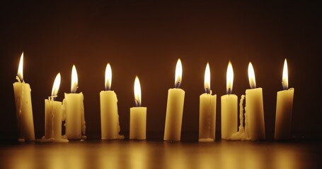 Candles glowing against dark background