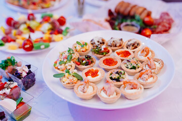 plate with tartlets. snack for buffet. catering for the holiday. 