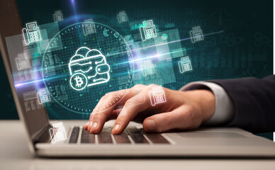 business hand working in stock market with bitcoin wallet icons coming out from laptop screen