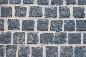 Old black paving stones. Top view. Close-up. Background. Texture.