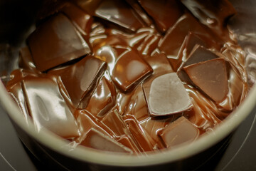 melted dark chocolate. Pieces of chocolate are melted to the state of chocolate sauce