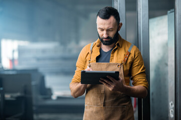 Worker with a digital tablet at the plant