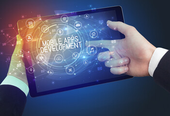 Close-up of a tablet with MOBILE APPS DEVELOPMENT inscription, innovative technology concept
