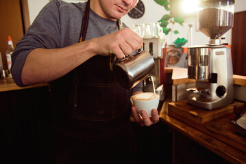 Coffee Latte Barista making pattern in a cup of coffee shop.