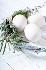 easter wreath with white wooden eggs on bright table