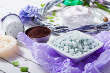 cosmetic cream product samples with hyacinth flowers on white wooden background