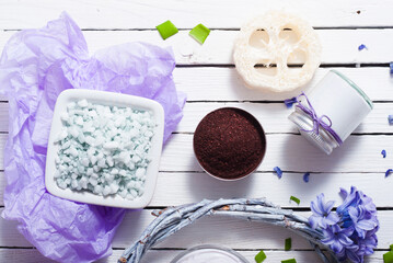cosmetic cream product samples with hyacinth flowers on white wooden background