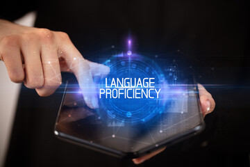 Young man holding a foldable smartphone with LANGUAGE PROFICIENCY inscription, educational concept