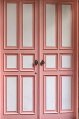 Neat door in white and pink rectangles with patterned metal handles in old town of Kaleici, Antalya, Turkey.