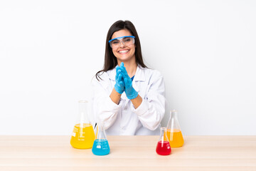 Young scientific woman in a table applauding after presentation in a conference