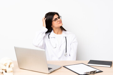 Professional traumatologist in workplace having doubts and with confuse face expression