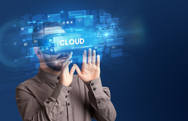 Businessman looking through Virtual Reality glasses with CLOUD inscription, innovative security concept