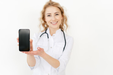 Doctor showing smartphone with copy space display