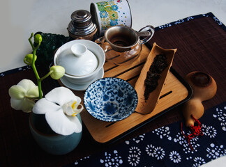 Tea set and white orchid.  Candid.