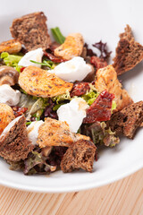 Closeup salad with croutons and grilled chicken