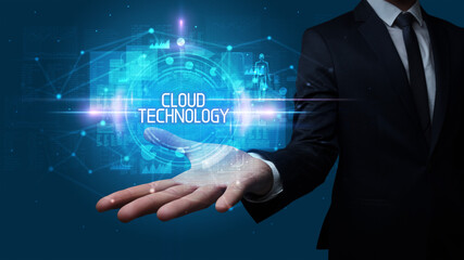 Man hand holding CLOUD TECHNOLOGY inscription, technology concept