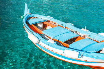 Fishing boat on crystal clear blue water