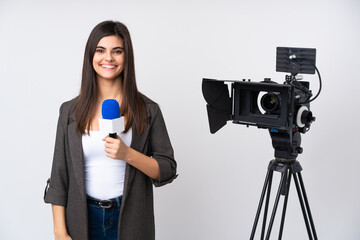 Reporter woman holding a microphone and reporting news over isolated white background