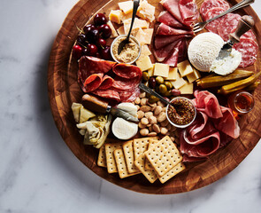 Naklejka na ściany i meble Luxurious Charcuterie Board with Cheese, Fruit, Meat, and Pickles