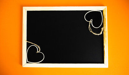 Two little hearts on black board - Top view.