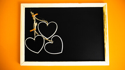  Beautiful heart shaped wooden little hearts on black board. 