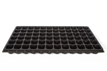 Naklejka premium Black cassette for seedlings on a white background.
