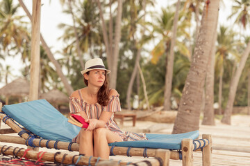 Woman reading a book on the beach