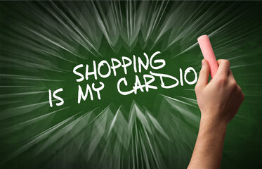 Hand drawing SHOPPING IS MY CARDIO inscription with white chalk on blackboard, online shopping concept