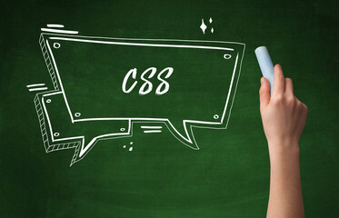 Hand drawing CSS abbreviation with white chalk on blackboard