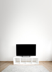 Lcd tv on white shef at modern room interior. Copy space