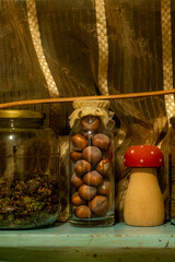 Collection of herbal tea and nuts on cozy rural kitchen shelf. Scandinavian interior design. Detailed photo of the rustic kitchen with decorations