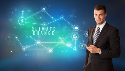 Businessman in front of cloud service icons with CLIMATE CHANGE inscription, modern technology concept