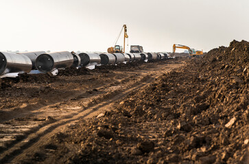 Crane digging a channel for gas pipeline
