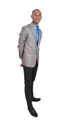 adult businessman with arms crossed behind his back.