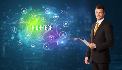 Businessman thinking in front of technology related icons and HIGH-TECH inscription, modern technology concept