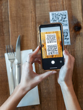 Young Woman Hands Using The Smart Phone To Scan The Qr Code To Select Food Menu In The Restaurant.