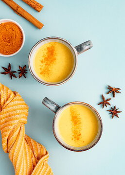 Indian Traditional Drink Turmeric Milk Latte On Blue Background