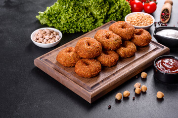 Beautiful delicious fresh chickpea falafel with sauces on a concrete background