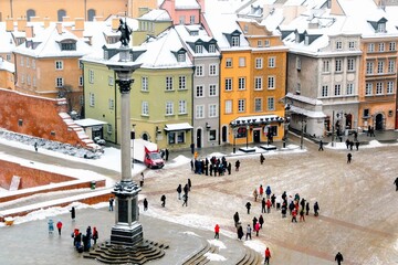 Winter at Castle Square in Warsaw - aerial view from the bell tower of the  St. Anne church. Snow...