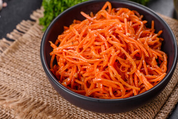 Delicious spicy juicy bright Korean carrots in ceramic dishes