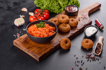 Delicious spicy juicy bright Korean carrots in ceramic dishes