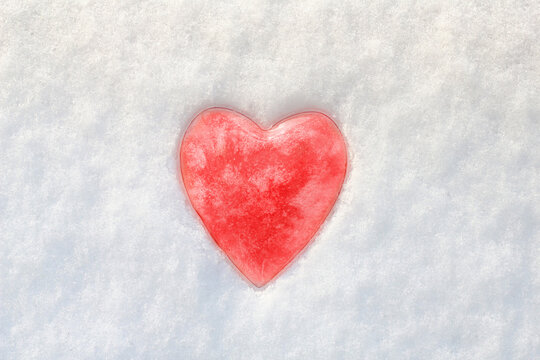 Red heart in the snow. Valentine's Day theme